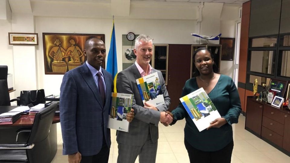 From left to right, RMB CEO, Dr. Francis Gatare, Gasmeth CEO, Stephen Tierney and RDB CEO, Ms. Clare Akamanzi pose with Invest in Rwanda booklets after signing the Methane gas extraction agreement at RDB office