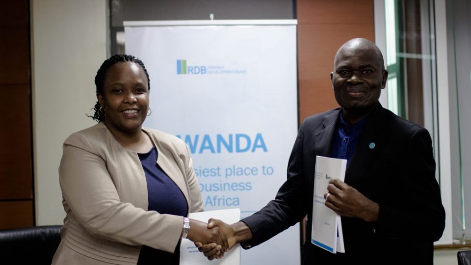 RDB CEO, Clare Akamanzi (L) shakes hands with FAO Representative in Rwanda, Gaulbert Gbehounou (R), after signing the new partnership today at RDB offices